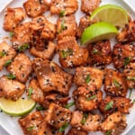 Plate of air fryer salmon bites with lime wedges