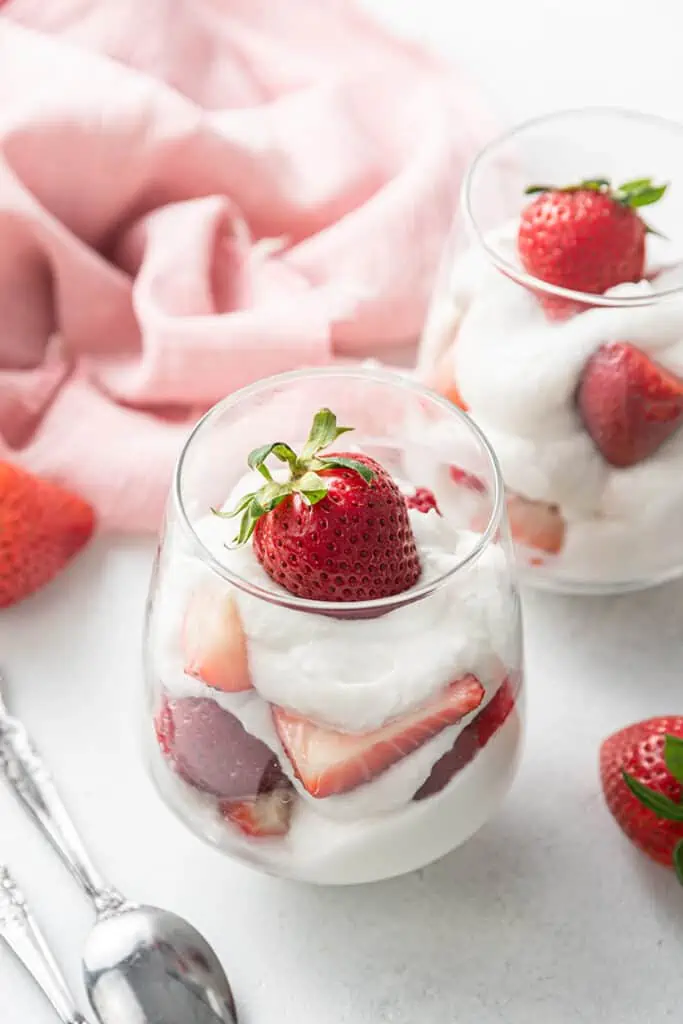glasses with coconut whipped cream and strawberries